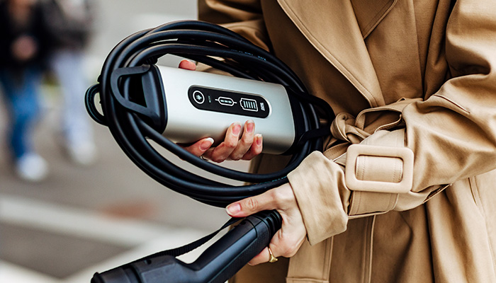 Woman holding a wrapped eMove portable charger