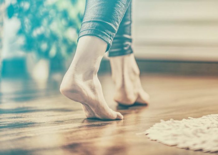 Bare feet on a parquet floor. Control floor heating with DEFA Cabin Control